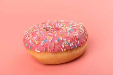 Fresh made Donuts isolated on pink background. Doughnuts are traditional sweet pastries. Copy space for text.
