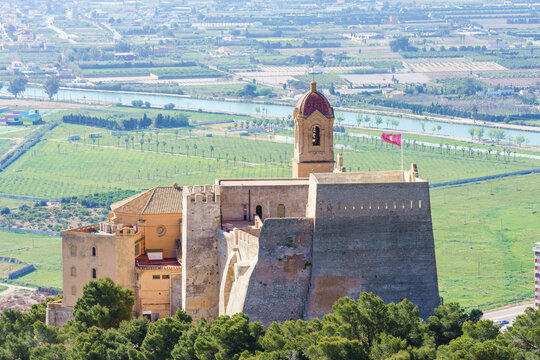 Castle and walls of Cullera Valencia Spain in the background Ribera Baixa landscape.