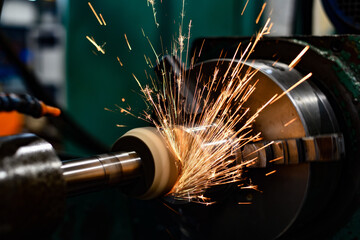 Grinding of parts on a machine, sparks from an abrasive wheel.