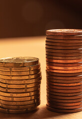 Close up view of two coin towers. Save money concept banner.