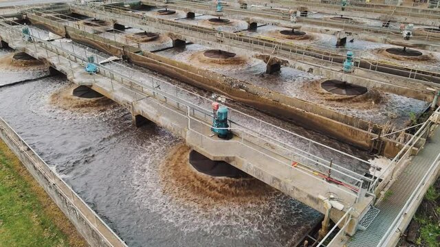 Aerial of water purification circle, clean drinking water. Ecosystem of filtration, fresh water and water management. Sewage treatment plant in the sun