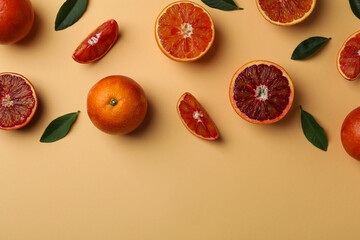 Red oranges and leaves on beige background