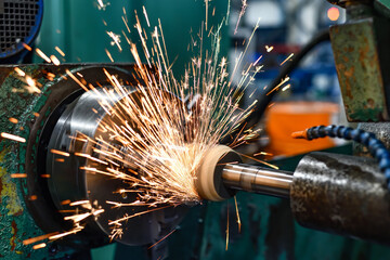 Grinding of parts on a machine, sparks from an abrasive wheel.