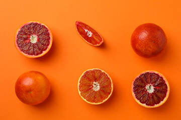 Flat lay with red oranges on orange background