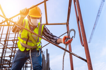 Worker working at height equipment constructive at construction site. Fall arrestor device for...