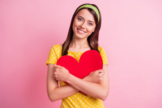 Photo of young attractive lovely pretty smiling cheerful girl hug embrace big red heart isolated on pink color background