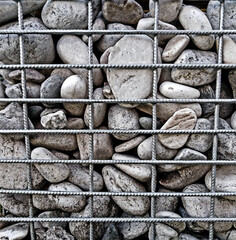 stones behind a metal lattice, background, texture