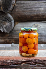 Tomatoes in a glass jar, homemade pickles