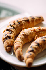 Closeup on a plate of sweet baked chocolate bagels