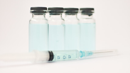 Medical ampoules and insulin syringe isolated on white background, vaccination concept