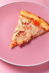 Slice of pizza in a plate on a pink background, space for text, Valentine's Day concept