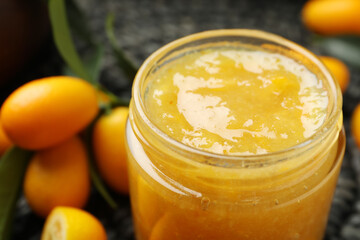 Delicious kumquat jam in jar, closeup view
