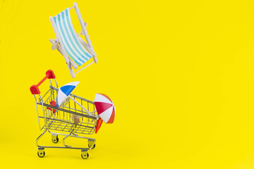 Vacation travel tour sale concept. Tourism opening. Sun lounger and summer umbrella in a shopping...