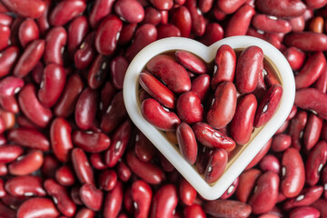 Red bean beans together with a heart shape as pattern background
