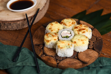 baked rolls with mozzarella and parmesan cheese cap on a wooden board decorated with bamboo leaves