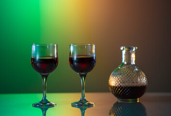 Red wine in the glass on the table. reflected glass. Summer mood