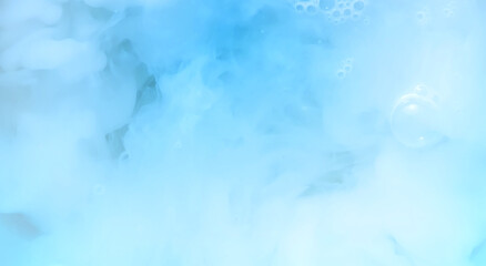 Abstract blue background of ink. Milk dissolves in water