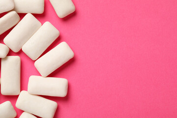 Many chewing gum pieces on pink background, flat lay. Space for text