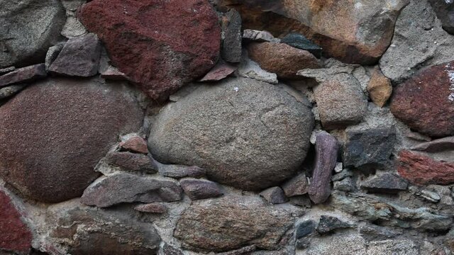ancient stone wall of granite cobblestones colorful pebbles