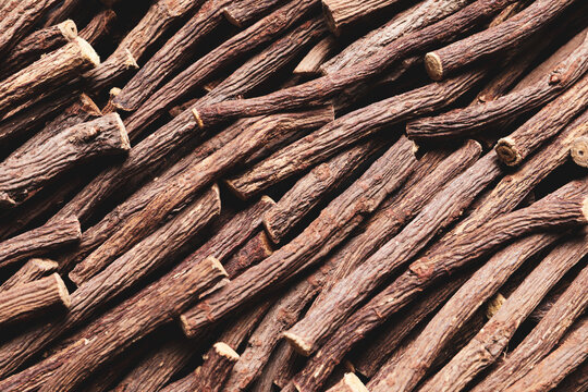 Dried sticks of liquorice root as background, top view