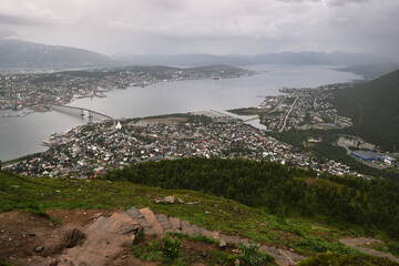 Wonderful view of the city of Tromso from the top of a mountain during a cloudy day