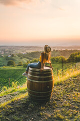 Happy girl on top of vineyard hill at sunset in Friuli Venezia Giulia region, Italy