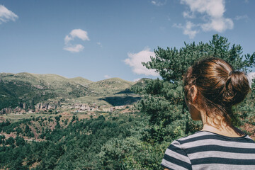 Girl walking along a small path in the mountain of Spain.