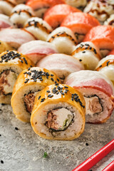 Sushi set. Uromaki with Philadelphia, with vegetables and fish