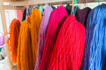 Raw wool available in several different colors displayed in a traditional shop in Ecuador.