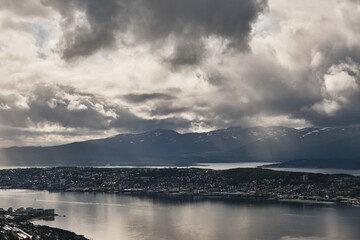 Scenic view of clouds over sea and city in Norway