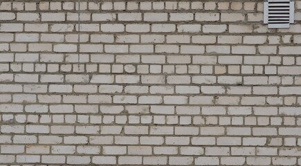 White brick wall with ventilation grate. The exterior of the building. High quality photo
