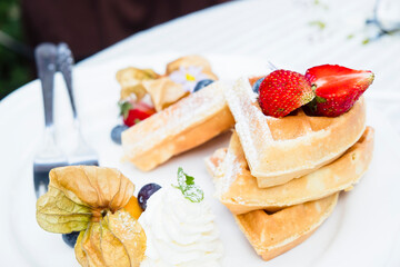 Homemade breakfast  Strawberry and tropical fruits  Waffles with  chocolate syrup 
