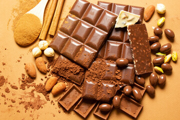 White and milk chocolates. Almond, pistachio, hazelnut.. background, texture..