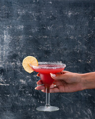 Red Strawberry or raspberry margarita cocktail with tequila orange syrup lemon