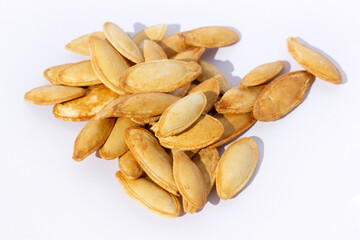 Pile of toasted Pumpkin seeds on white background