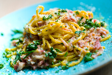 Pasta carbonara on a turquoise plate