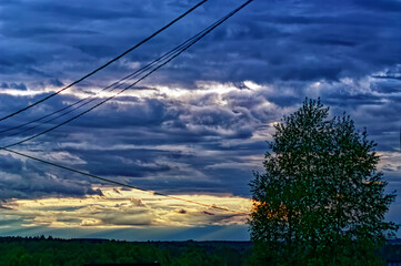 sunset in the overcast sky in the village