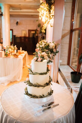 Wedding decor in a restaurant, the wedding cake on the table