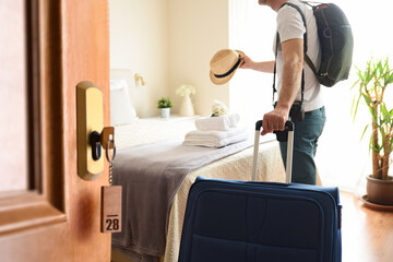 Man entering through the door of a bright holiday room