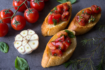 Italian bruschetta with roasted tomatoes, basil and garlic. Top view photo of savory toast. Healthy eating concept. 