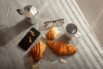 Breakfast with croissant and coffee and moka pot. Morning meal and breakfast concept.