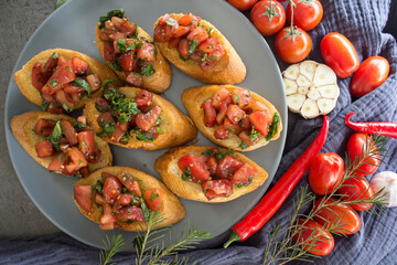 Italian bruschetta with roasted tomatoes, basil and garlic. Top view photo of savory toast. Healthy eating concept. 