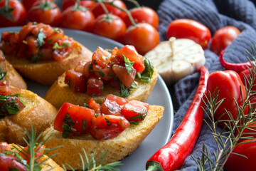Italian bruschetta with roasted tomatoes, basil and garlic. Top view photo of savory toast. Healthy eating concept. 