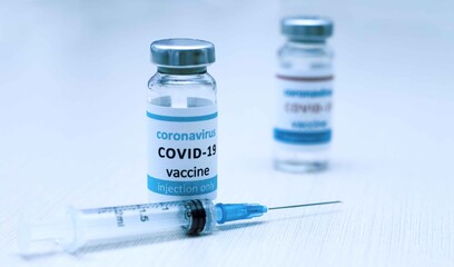 Coronavirus vaccine. The medical concept. Ampoule and syringe.