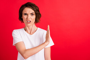 Portrait of attractive mad girl showing aside stop sign copy space disgust isolated over bright red...