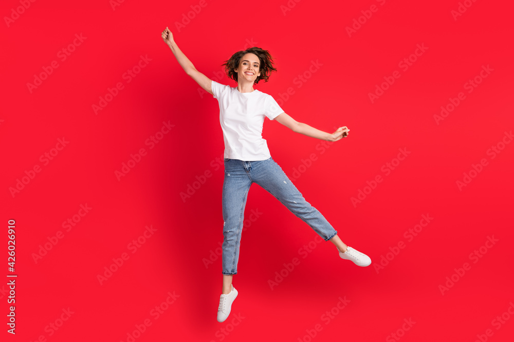 Wall mural full length body size view of attractive cheerful skinny girl jumping having fun fooling isolated ov