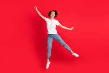 Full length body size view of attractive cheerful skinny girl jumping having fun fooling isolated...