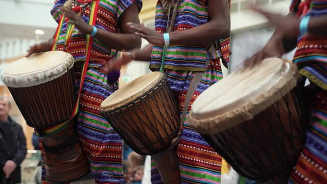 Man playing drum by his hands. Street performance using percussion instruments in slow motion