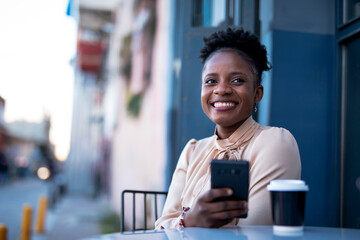 Obraz na płótnie Canvas Businesswoman using the phone in cafe. Beautiful woman on coffee break.
