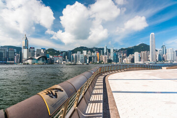 Tourists visiting the Avenue of the Stars. The Avenue of Stars is located along the Victoria Harbor in Hong Kong.  - obrazy, fototapety, plakaty